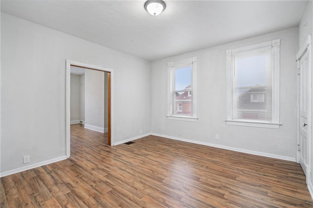 200 Moye Place Pittsburgh, PA 15210 - Photo 18 of 36 a view of an empty room with wooden floor and a window