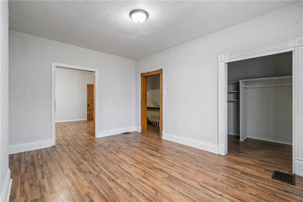 200 Moye Place Pittsburgh, PA 15210 - Photo 20 of 36 an empty room with wooden floor and closet