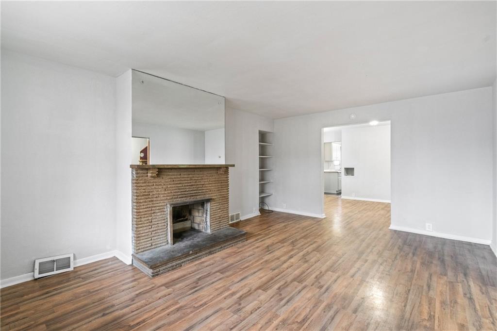 200 Moye Place Pittsburgh, PA 15210 - Photo 5 of 36 a view of empty room with wooden floor and fireplace