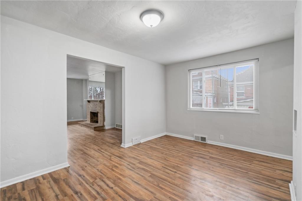 200 Moye Place Pittsburgh, PA 15210 - Photo 9 of 36 an empty room with wooden floor and windows