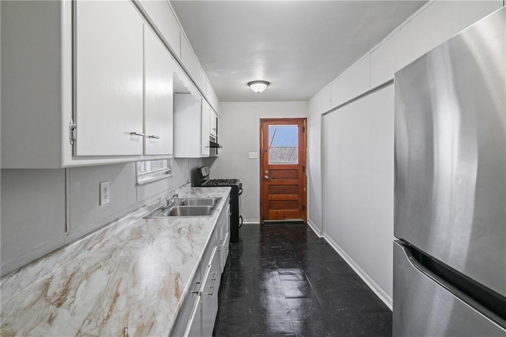 200 Moye Place Pittsburgh, PA 15210 - Photo 10 of 36 a kitchen with stainless steel appliances granite countertop a refrigerator and a stove