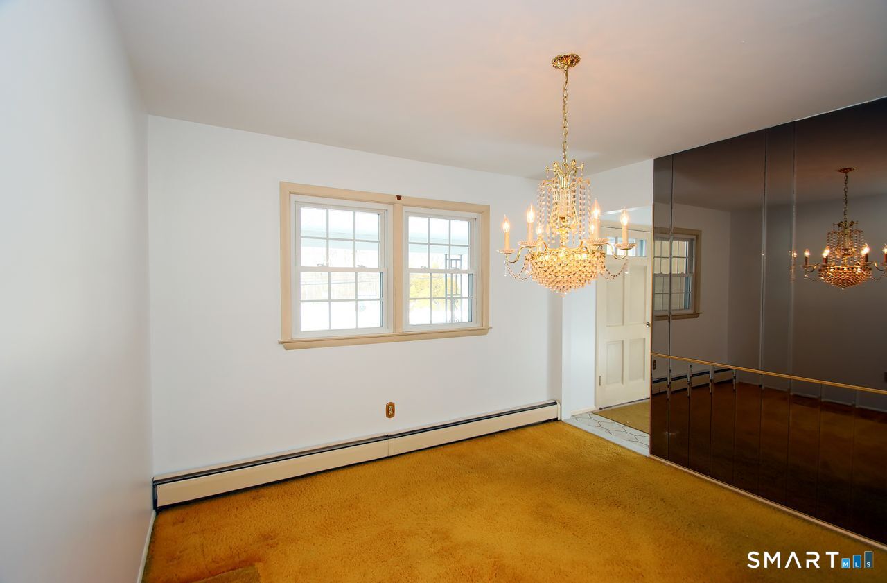 463 Herbert Street Orange, CT 06477 - Photo 11 of 40 a view of a room with window and chandelier