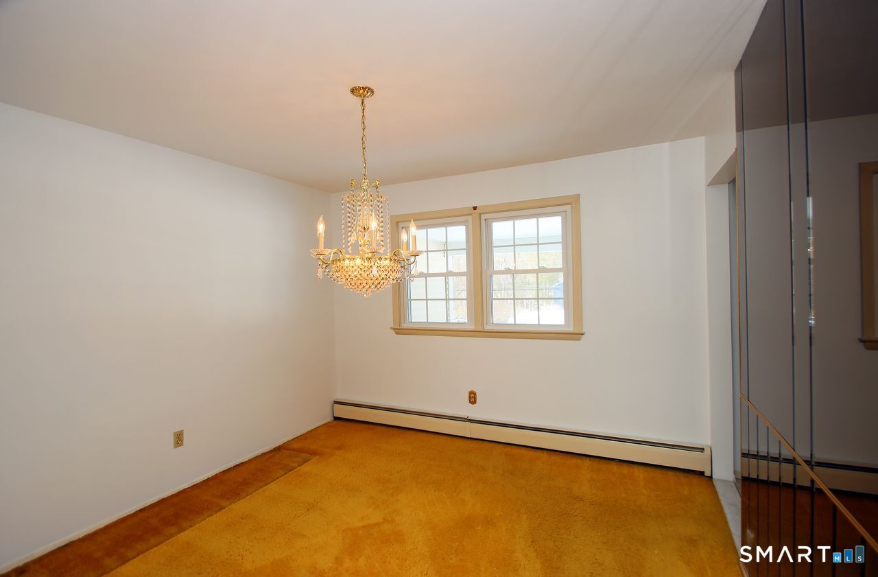 463 Herbert Street Orange, CT 06477 - Photo 12 of 40 a view of a room with windows and ceiling fan