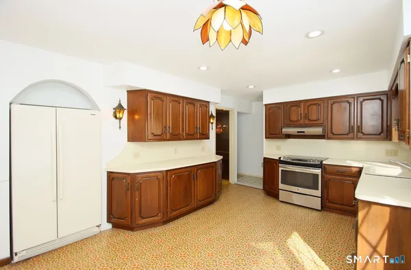 a kitchen with stainless steel appliances granite countertop a stove and a refrigerator