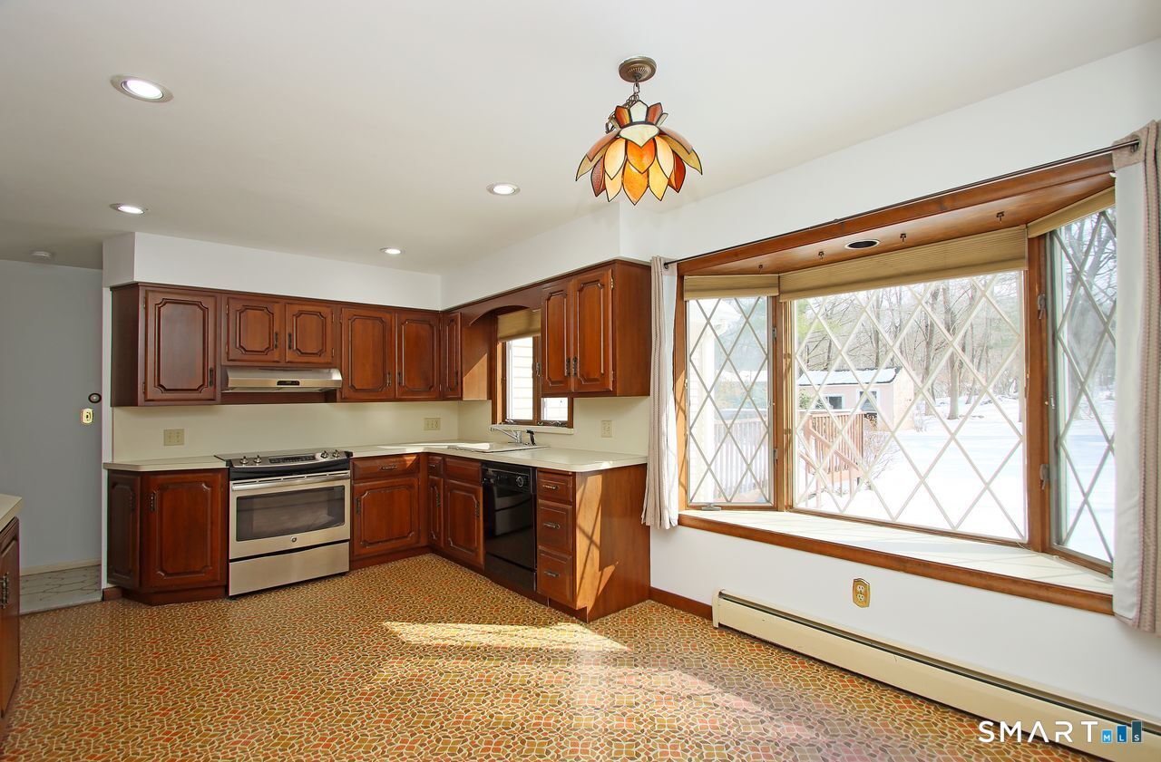 463 Herbert Street Orange, CT 06477 - Photo 14 of 40 a kitchen with stainless steel appliances granite countertop a stove and a sink