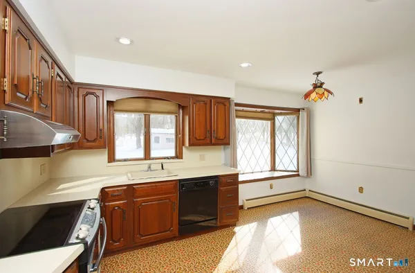 a spacious bathroom with a granite countertop sink and a bathtub