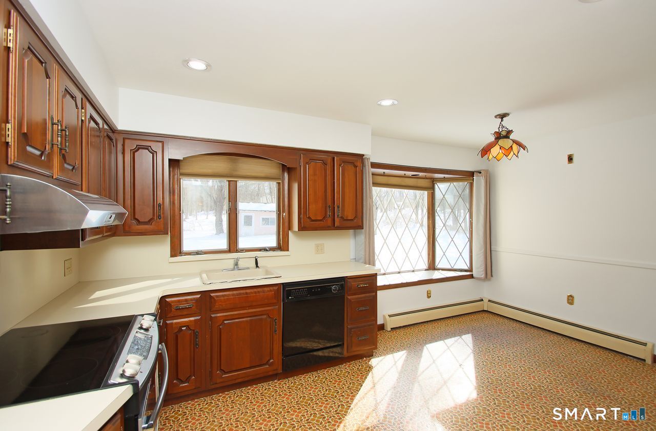 463 Herbert Street Orange, CT 06477 - Photo 15 of 40 a spacious bathroom with a granite countertop sink and a bathtub