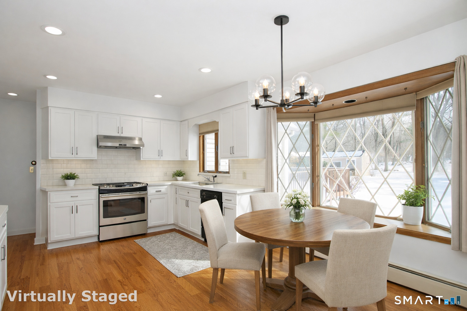 463 Herbert Street Orange, CT 06477 - Photo 23 of 51 a kitchen with a table chairs stove and cabinets