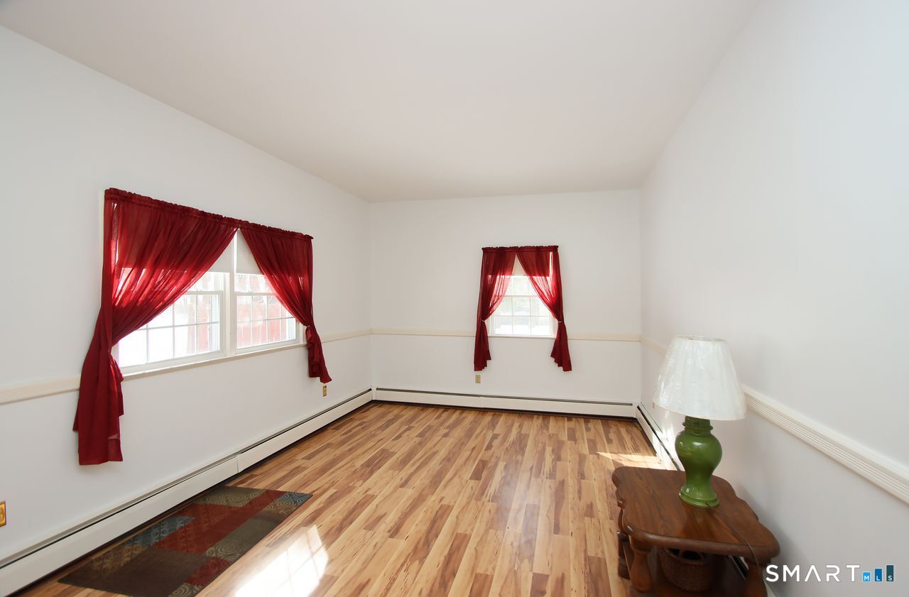 463 Herbert Street Orange, CT 06477 - Photo 24 of 51 a room with window and wooden floor