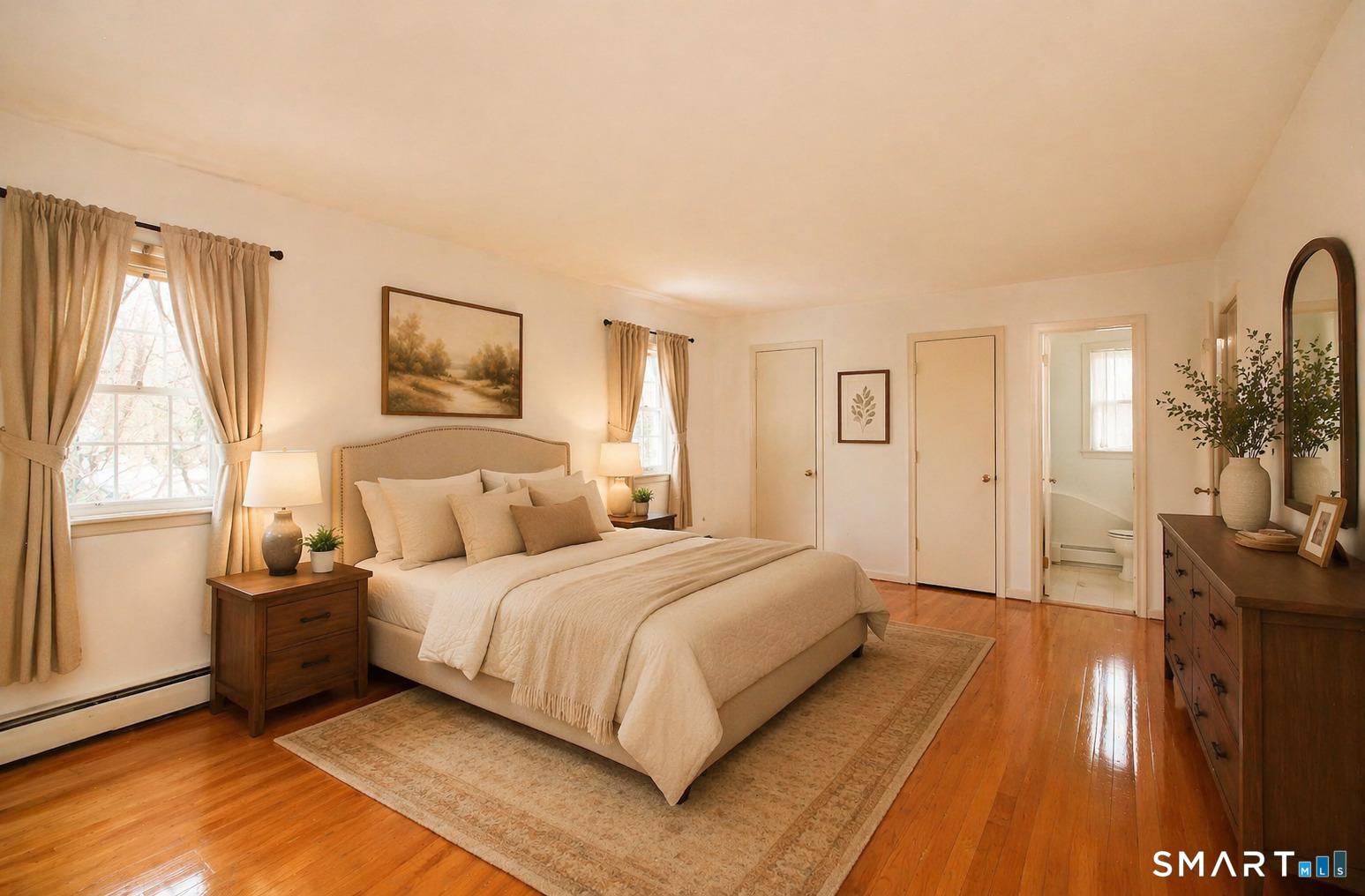 463 Herbert Street Orange, CT 06477 - Photo 27 of 51 a bedroom with a bed a mirror on dresser and a large window