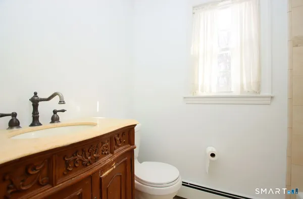a bathroom with a sink a toilet and vanity