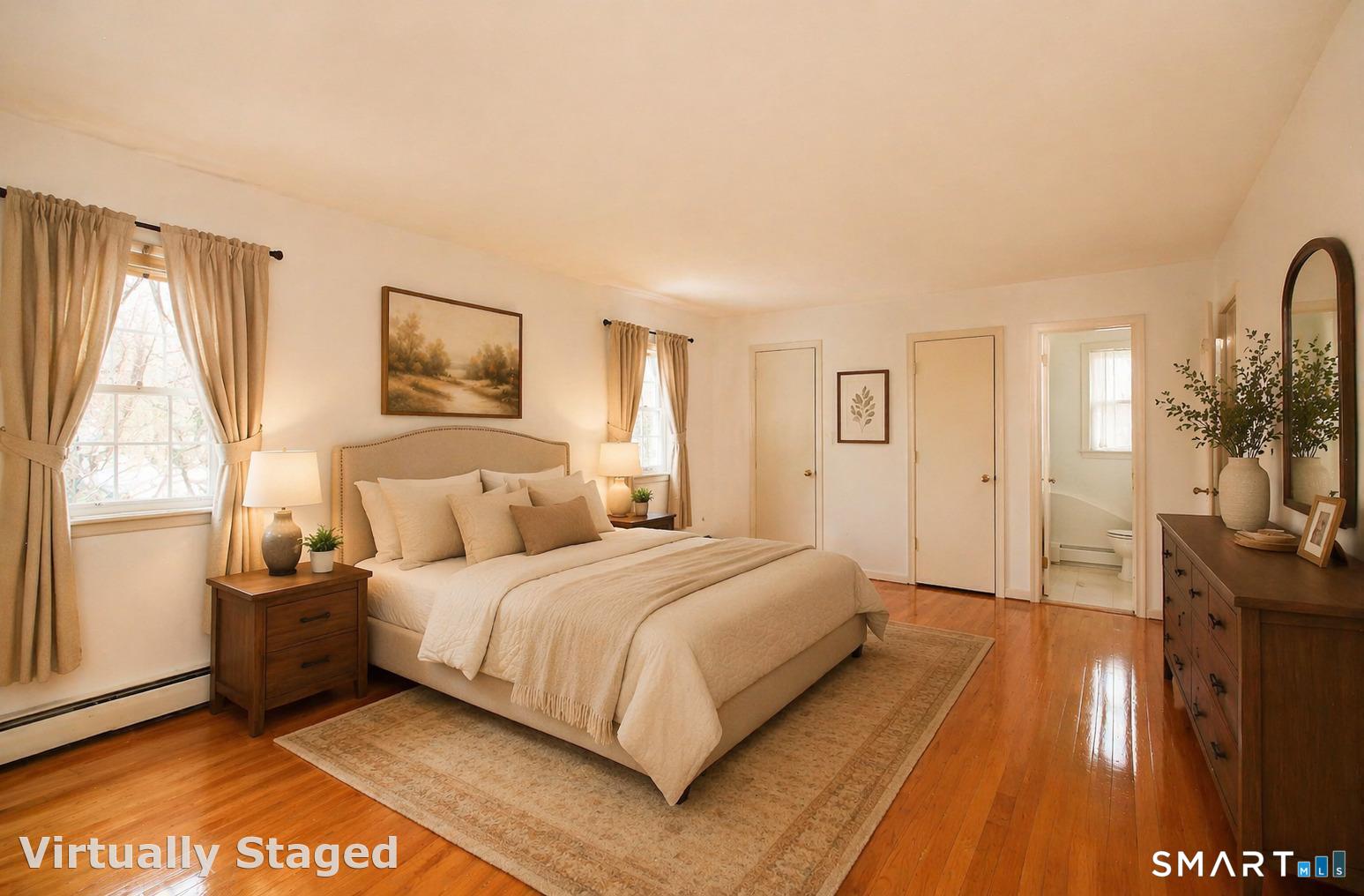 463 Herbert Street Orange, CT 06477 - Photo 28 of 51 a bedroom with a bed a mirror on dresser and a large window