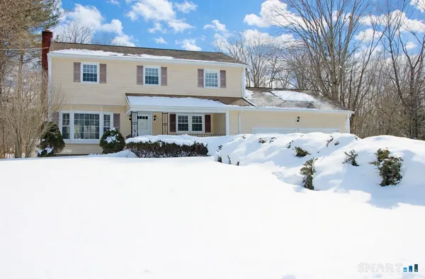 a view of a white house covered in snow