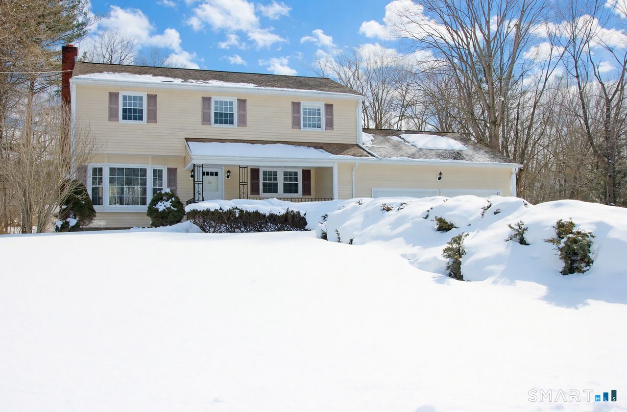 463 Herbert Street Orange, CT 06477 - Photo 3 of 40 a view of a white house covered in snow
