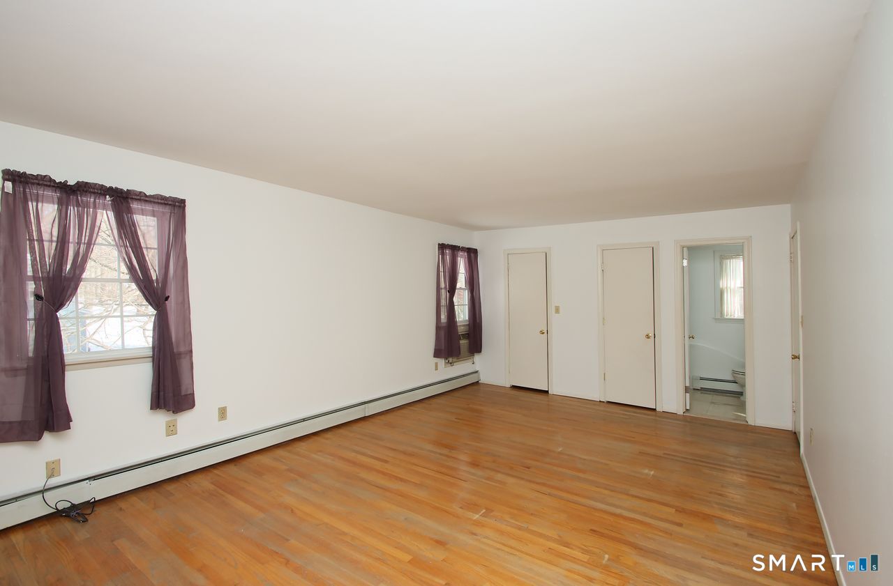 463 Herbert Street Orange, CT 06477 - Photo 34 of 51 wooden floor in an empty room with a window