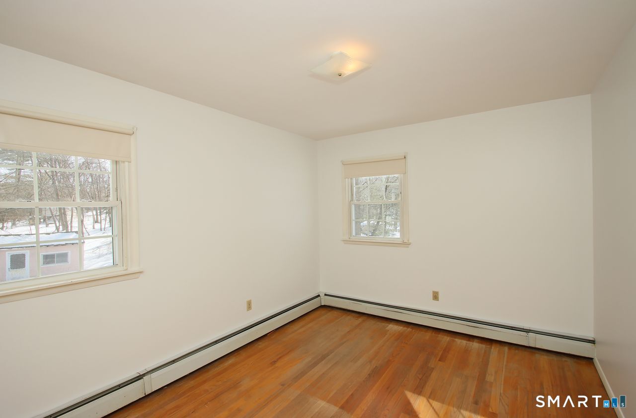 463 Herbert Street Orange, CT 06477 - Photo 37 of 51 a view of a room with a window and wooden floor