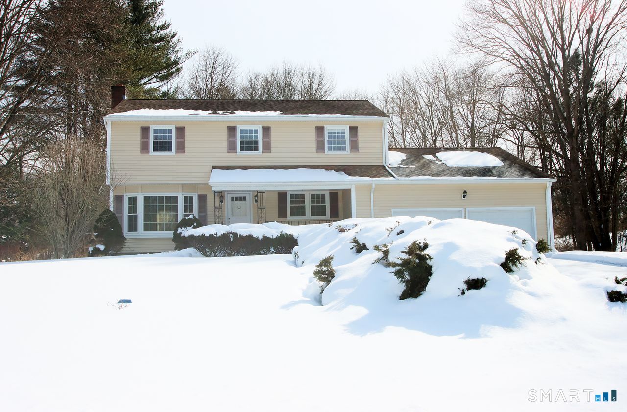 463 Herbert Street Orange, CT 06477 - Photo 51 of 51 a front view of a house with a yard covered in snow