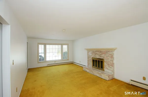 a living room with a fireplace and windows