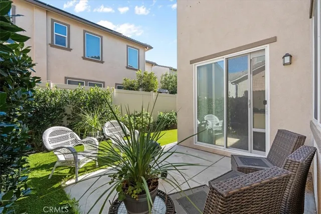 a view of a chair and tables in patio of the house