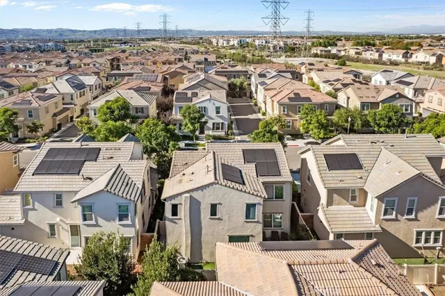 a picture of a bathroom with a refrigerator a sink and wooden floor