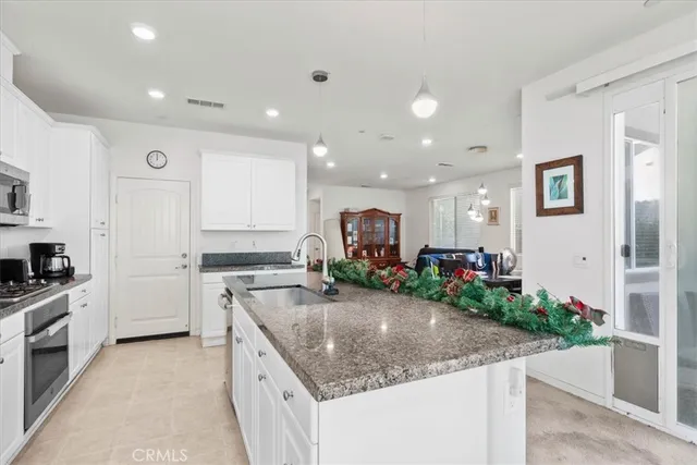 a kitchen with a sink stove and cabinets