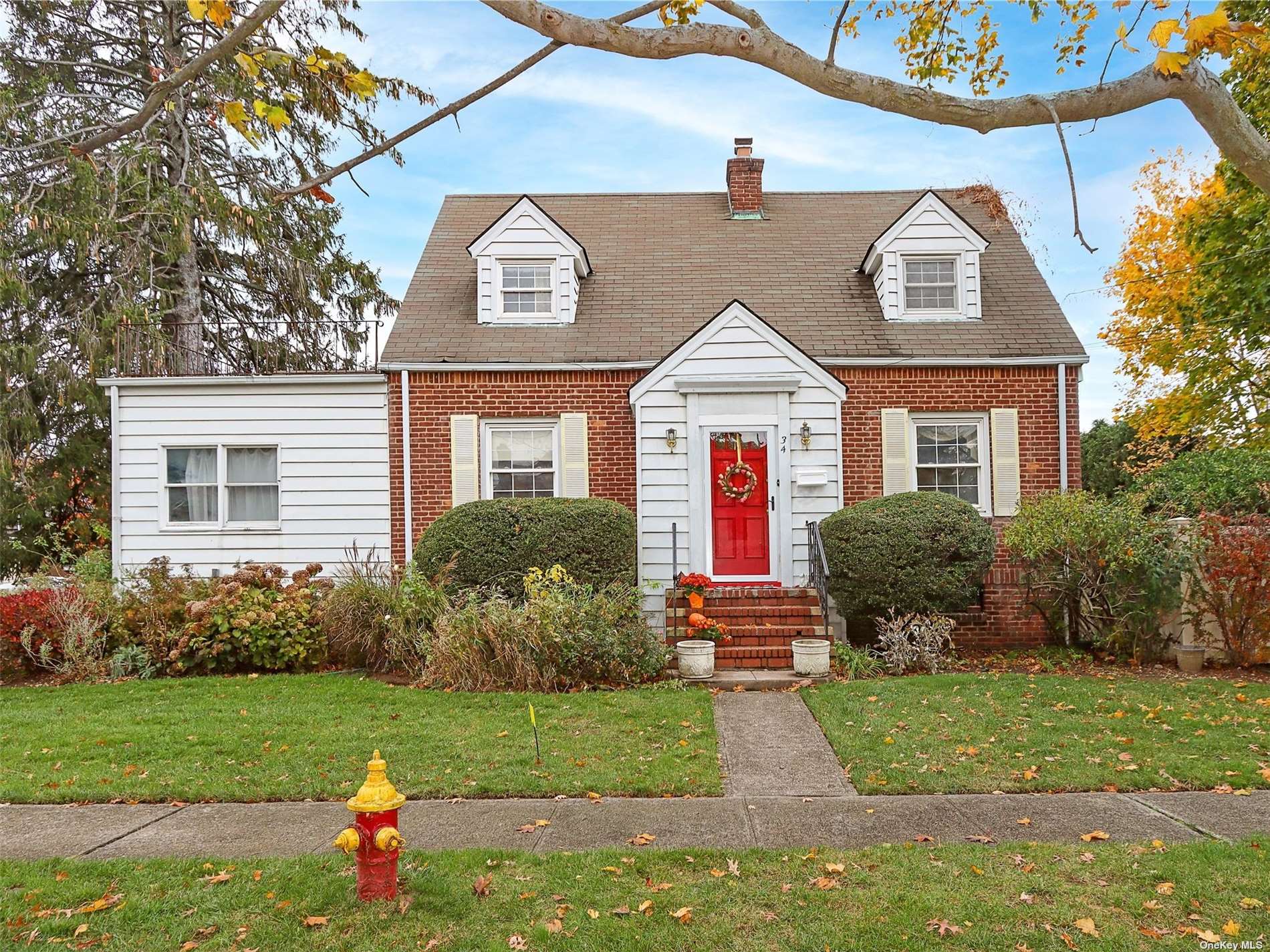 34 Buckingham Road Merrick, NY 11566 - Photo 1 of 1 a front view of a house with a yard