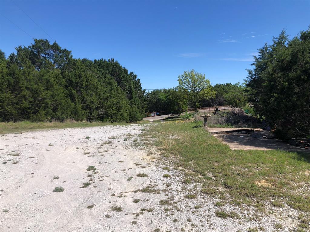 1408 Robyn Road Azle, TX 76020 - Photo 29 of 34 a backyard of a house with lots of green space