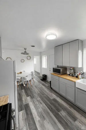 a view of a dining room with furniture and wooden floor