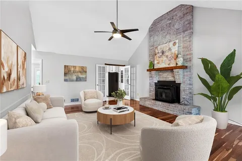 a view of empty room with fireplace and wooden floor