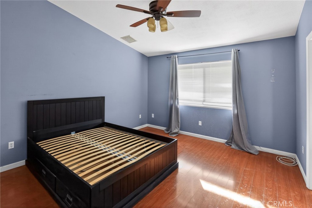 421 Petris Avenue Ridgecrest, CA 93555 - Photo 12 of 18 a bedroom with a bed and window