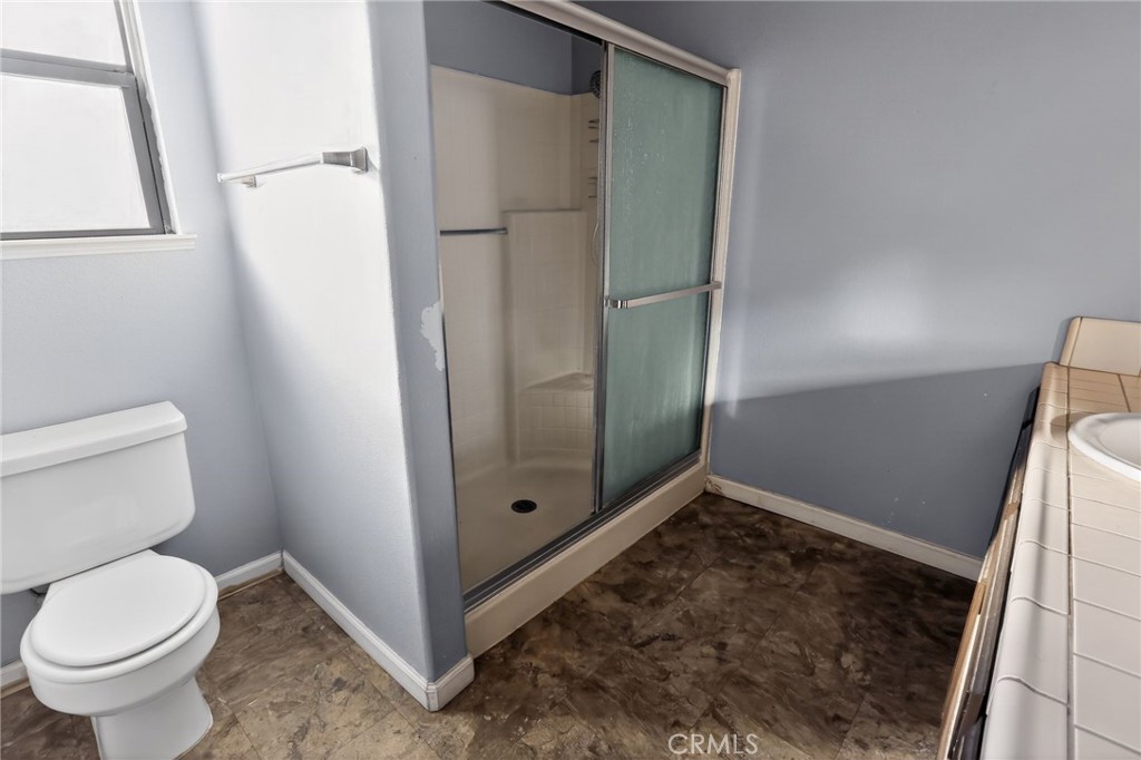421 Petris Avenue Ridgecrest, CA 93555 - Photo 13 of 18 a bathroom with a toilet and a shower