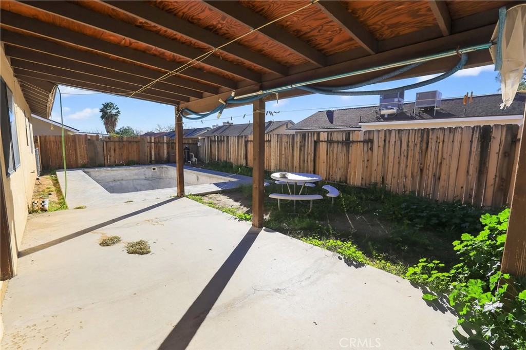 421 Petris Avenue Ridgecrest, CA 93555 - Photo 17 of 18 a view of a backyard with a wooden fence