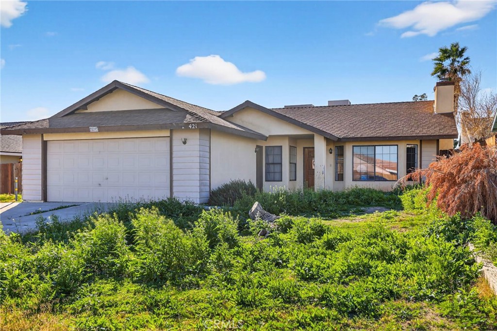 421 Petris Avenue Ridgecrest, CA 93555 - Photo 2 of 18 a front view of a house with garden