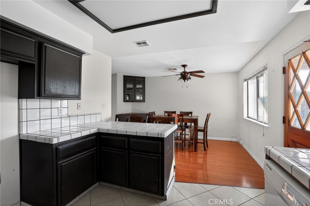 421 Petris Avenue Ridgecrest, CA 93555 - Photo 6 of 18 a kitchen with a sink window and cabinets