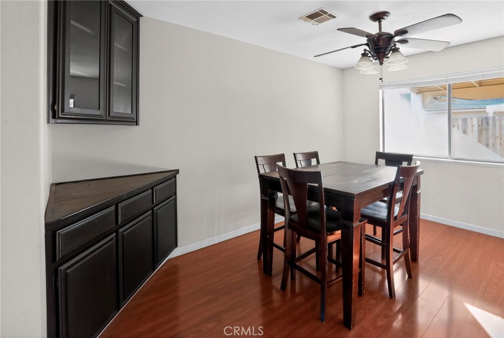 421 Petris Avenue Ridgecrest, CA 93555 - Photo 9 of 18 a view of a dining room with furniture and wooden floor