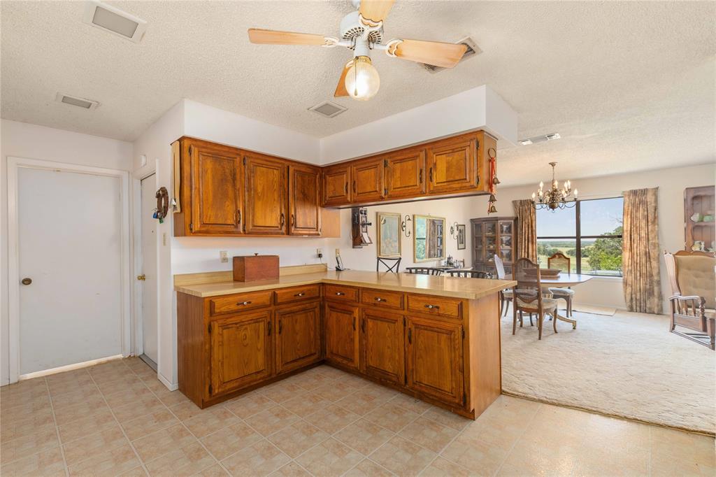 3718 Highway 36 Rising Star, TX 76471 - Photo 24 of 36 a open kitchen with stainless steel appliances granite countertop a sink and cabinets