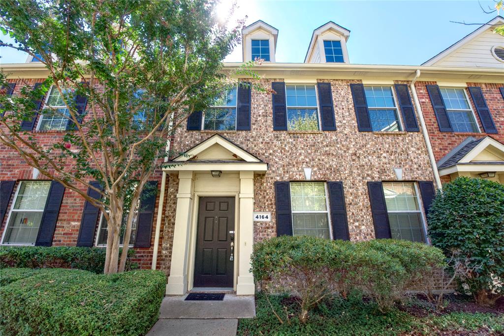a front view of residential houses with yard