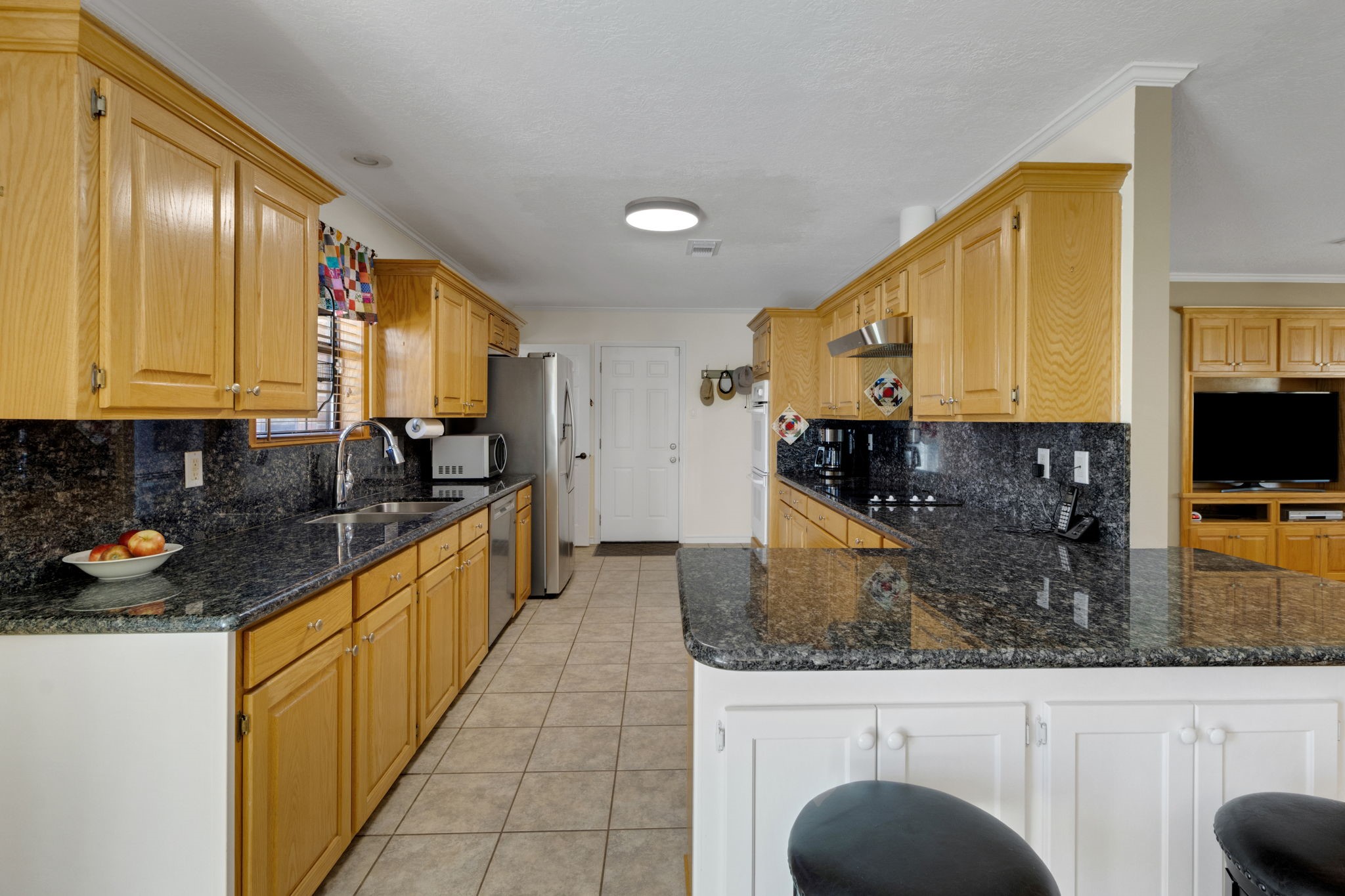 41 Holly Glen Point Blank, TX 77364 - Photo 14 of 35 a kitchen with stainless steel appliances granite countertop a sink a stove counter space and cabinets