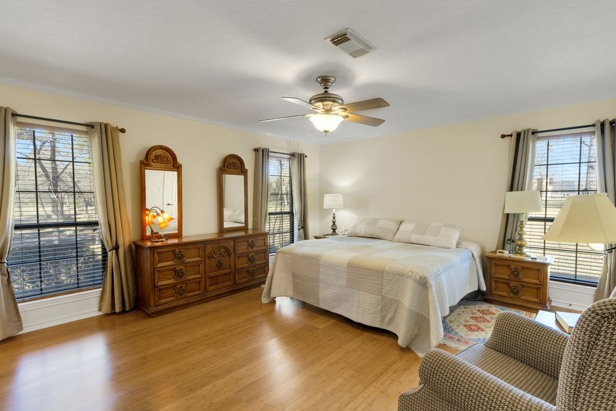 41 Holly Glen Point Blank, TX 77364 - Photo 17 of 35 a spacious bedroom with a bed a chandelier and dresser