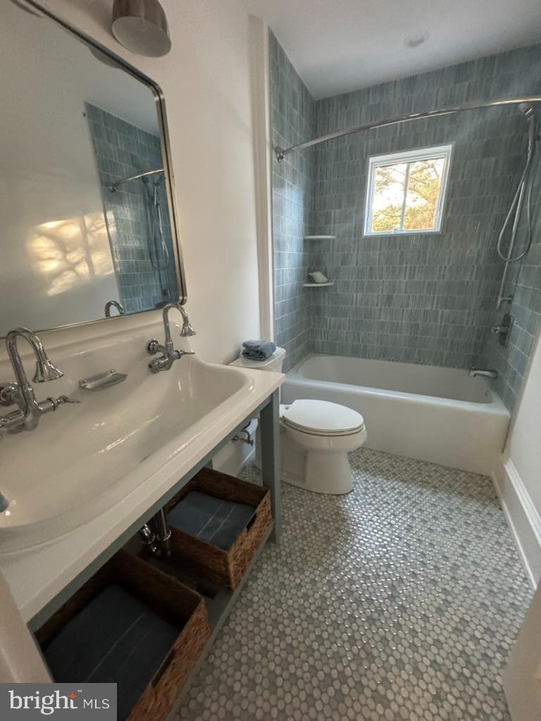 281 7th Street Avalon, NJ 08202 - Photo 16 of 62 a bathroom with a sink a toilet a mirror and bathtub