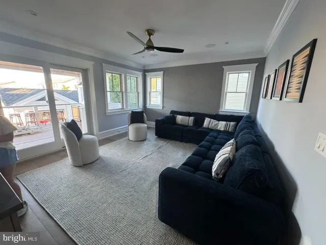 a living room with lots of furniture and a large window