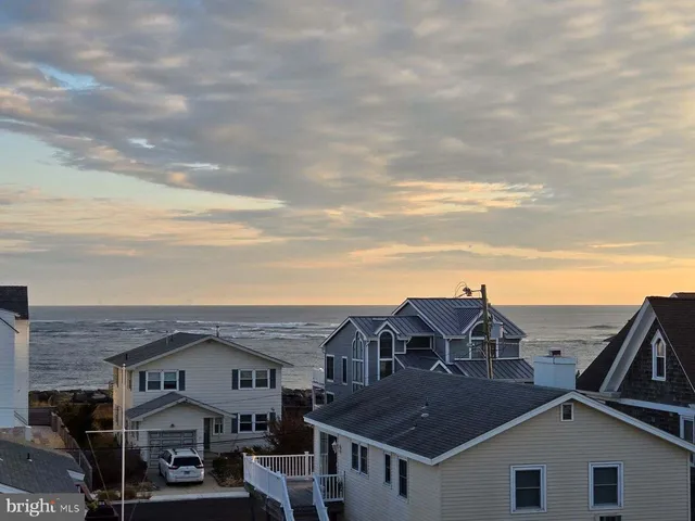 a view of a big house with a roof deck