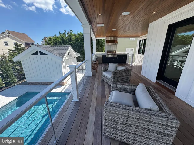 a dining room with furniture a chandelier and kitchen view