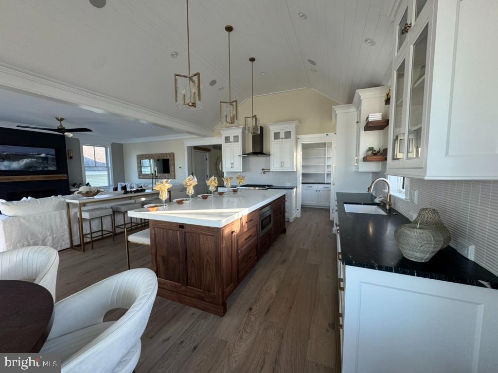 281 7th Street Avalon, NJ 08202 - Photo 28 of 62 a kitchen with stainless steel appliances granite countertop a sink dishwasher a stove and a refrigerator with wooden floor