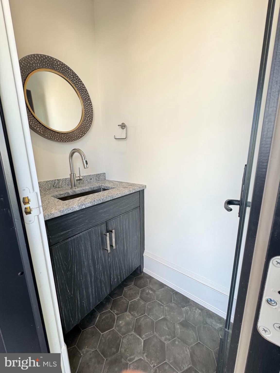 281 7th Street Avalon, NJ 08202 - Photo 53 of 62 a bathroom with a granite countertop sink and a mirror