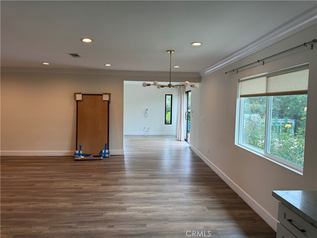 7459 Ruffner Avenue Van Nuys, CA 91406 - Photo 11 of 21 a view of an empty room with window and wooden floor