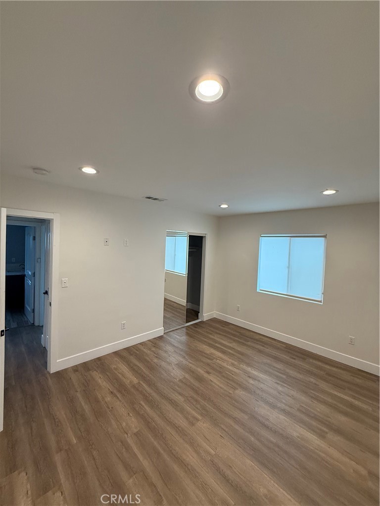 7459 Ruffner Avenue Van Nuys, CA 91406 - Photo 13 of 20 a view of an empty room with wooden floor and a window