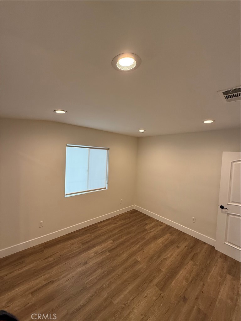 7459 Ruffner Avenue Van Nuys, CA 91406 - Photo 18 of 21 an empty room with wooden floor and windows