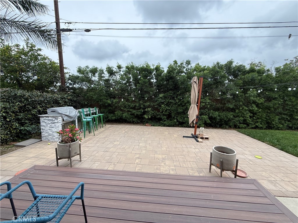 7459 Ruffner Avenue Van Nuys, CA 91406 - Photo 18 of 20 a terrace view with a bench and trees in the background
