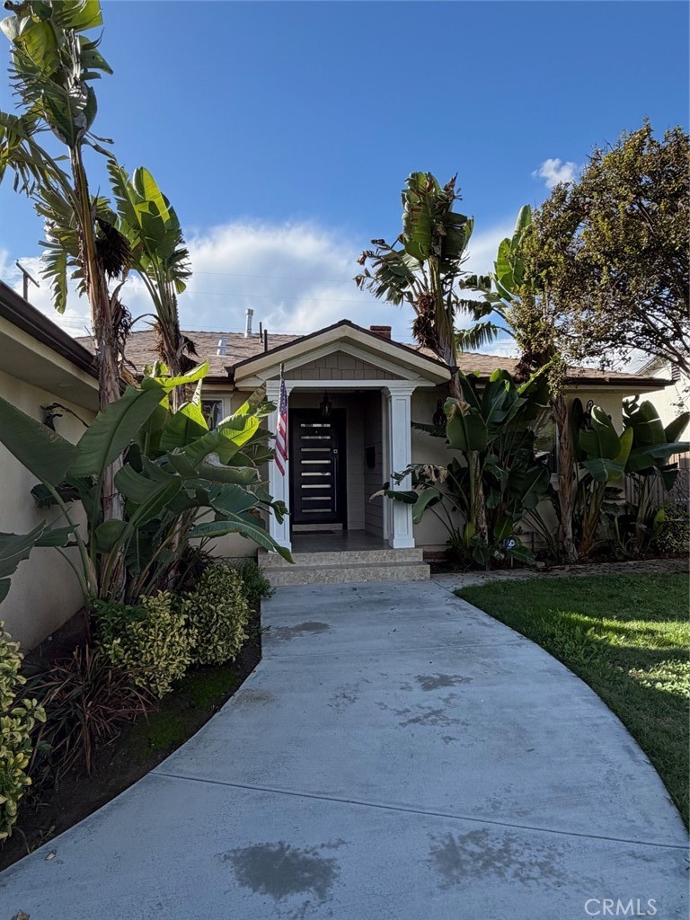 7459 Ruffner Avenue Van Nuys, CA 91406 - Photo 2 of 21 a front view of a house with a garden